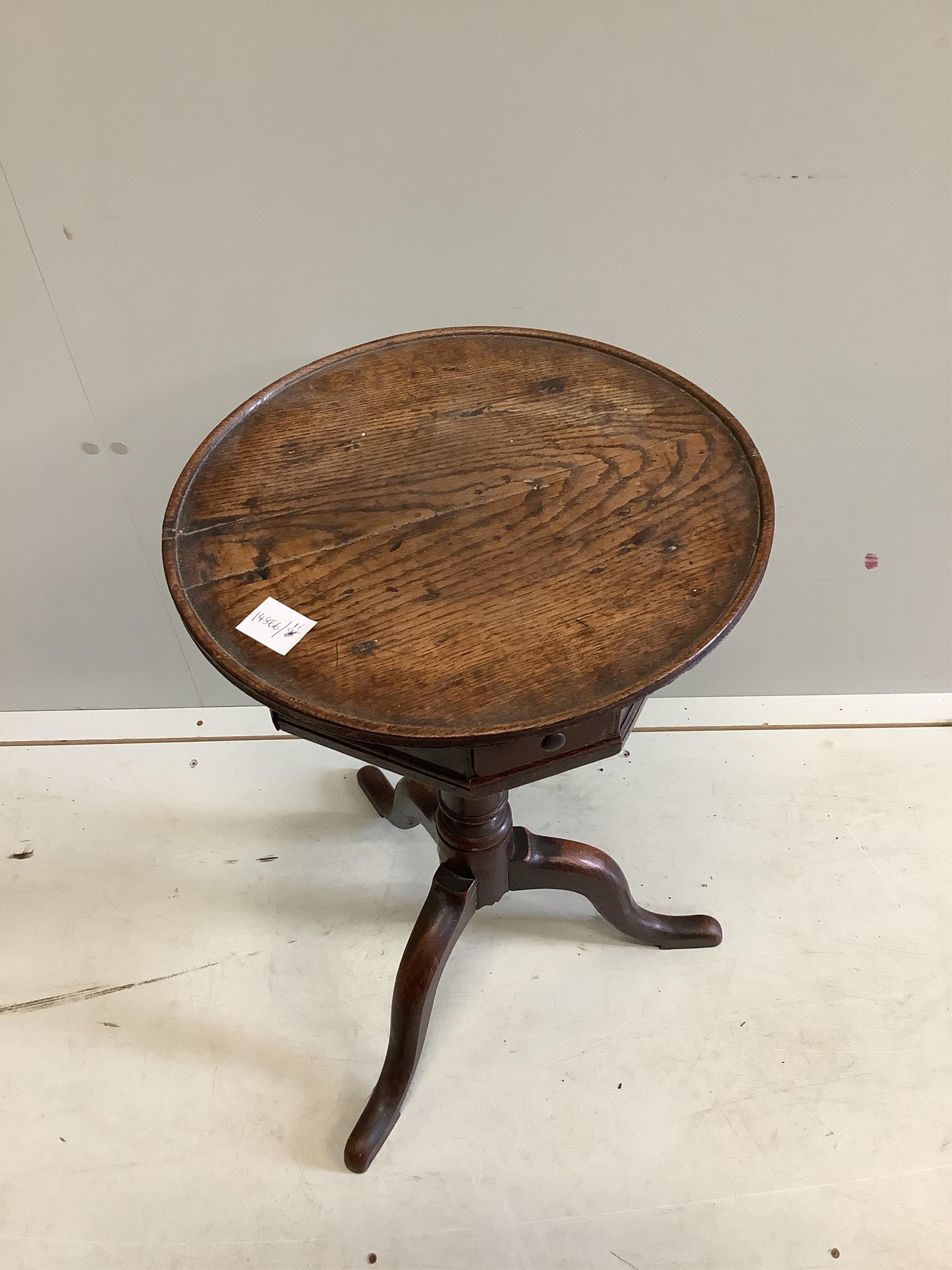 A George III provincial oak circular tripod wine table, fitted drawers, diameter 39cm, height 69cm. Condition - fair